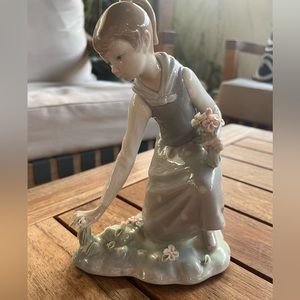 Lladro Girl picking flowers